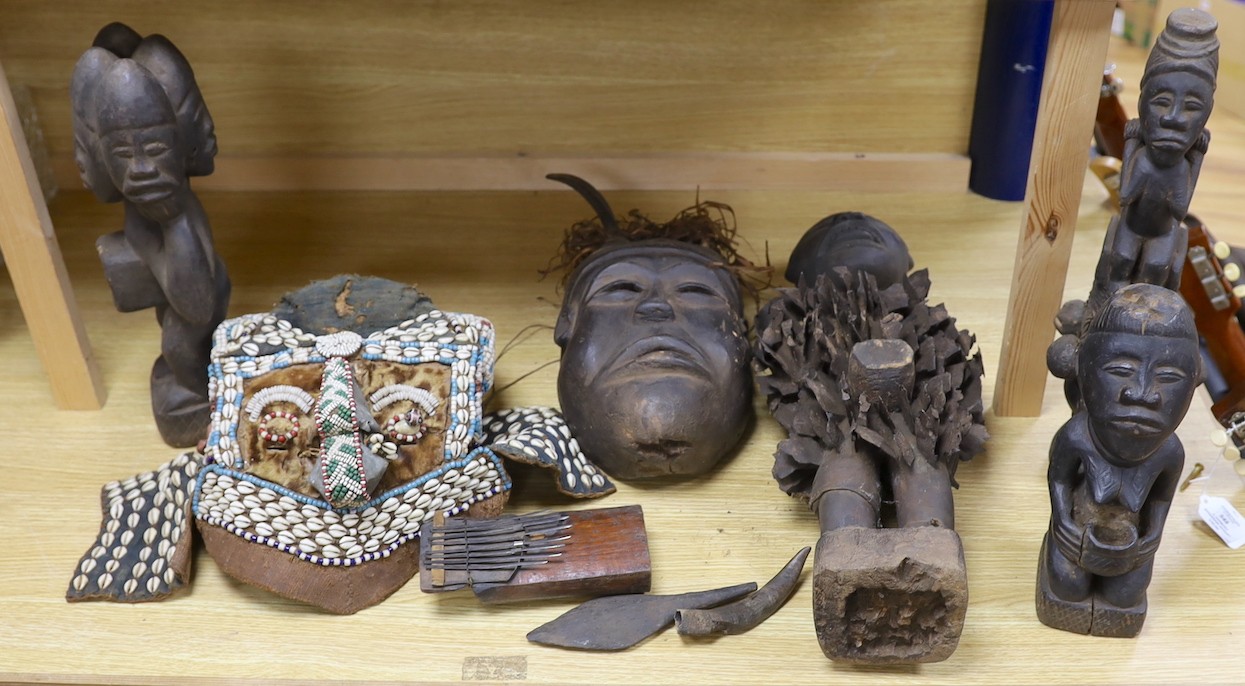 A group of Democratic Republic of Congo tribal carved wood figures and instrument and a Kuba style beadwork and shell mount mask